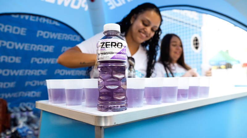 Powerade Zero grape samples poured into cups along the branded Powerade bar as ambassadors serve guests