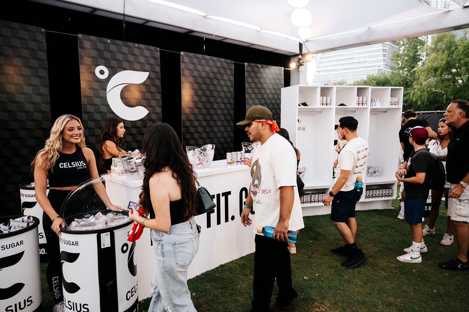 Celsius brand ambassadors sampling product to guests inside the branded activation