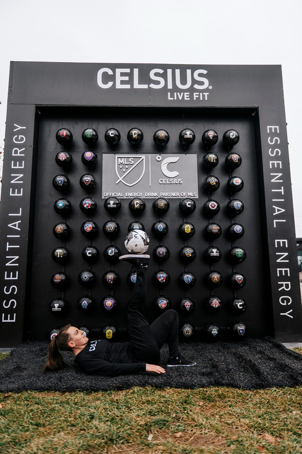 Athlete juggling a soccer ball in front of the Celsius all-club ball wall at MLS Cup