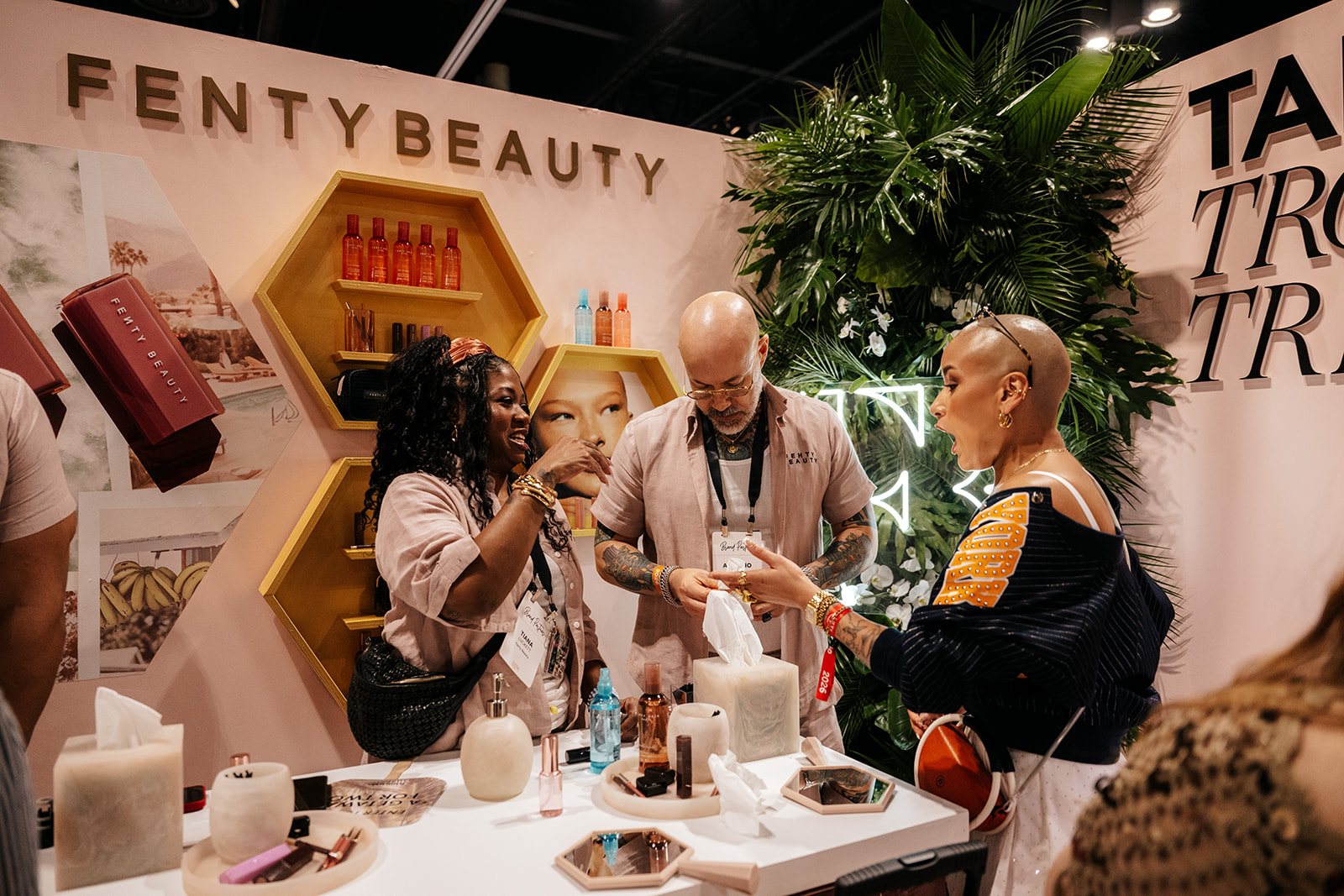 Guests interacting with Fenty Beauty products inside a branded activation