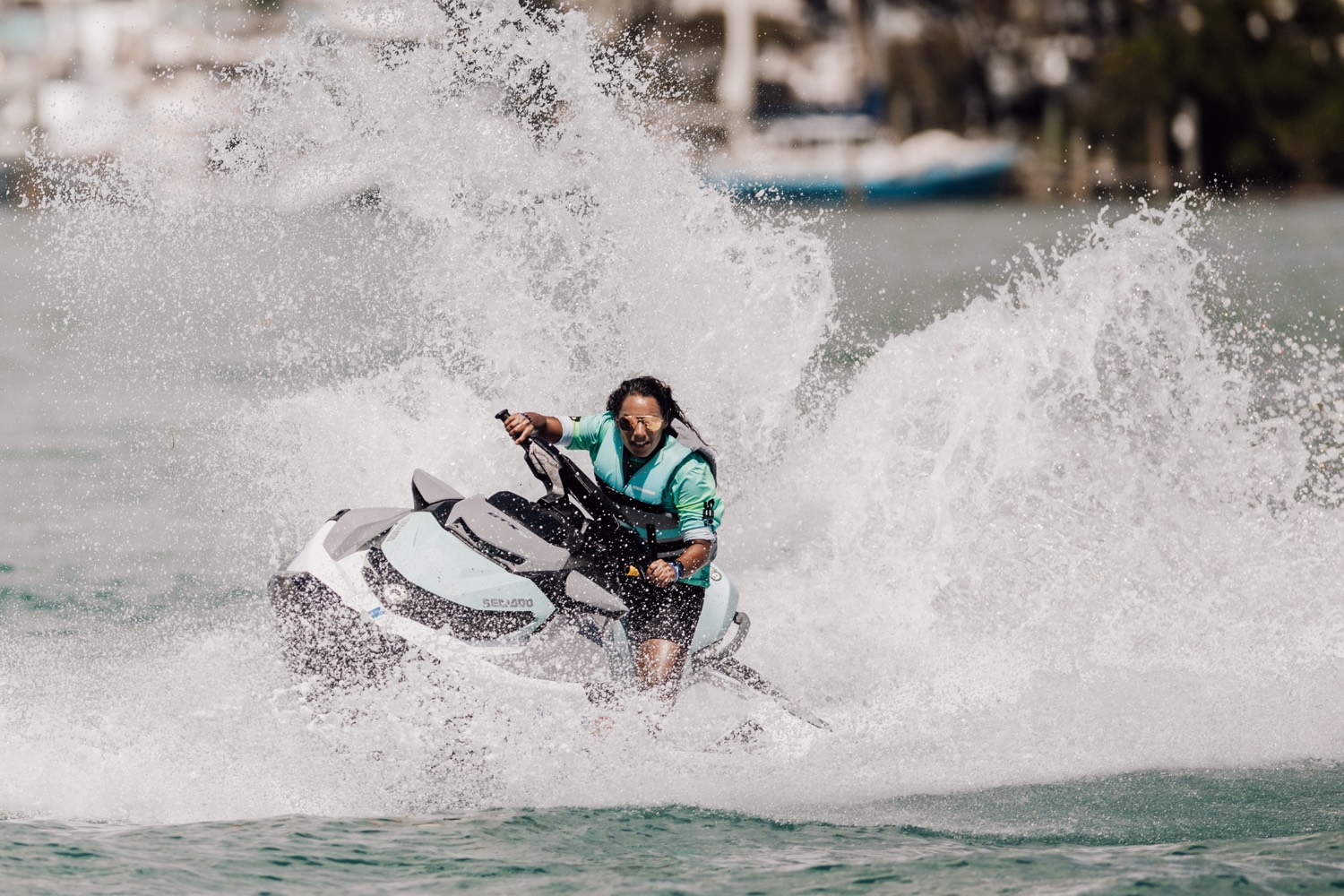 Rider blasting through a wall of spray on a Sea-Doo watercraft